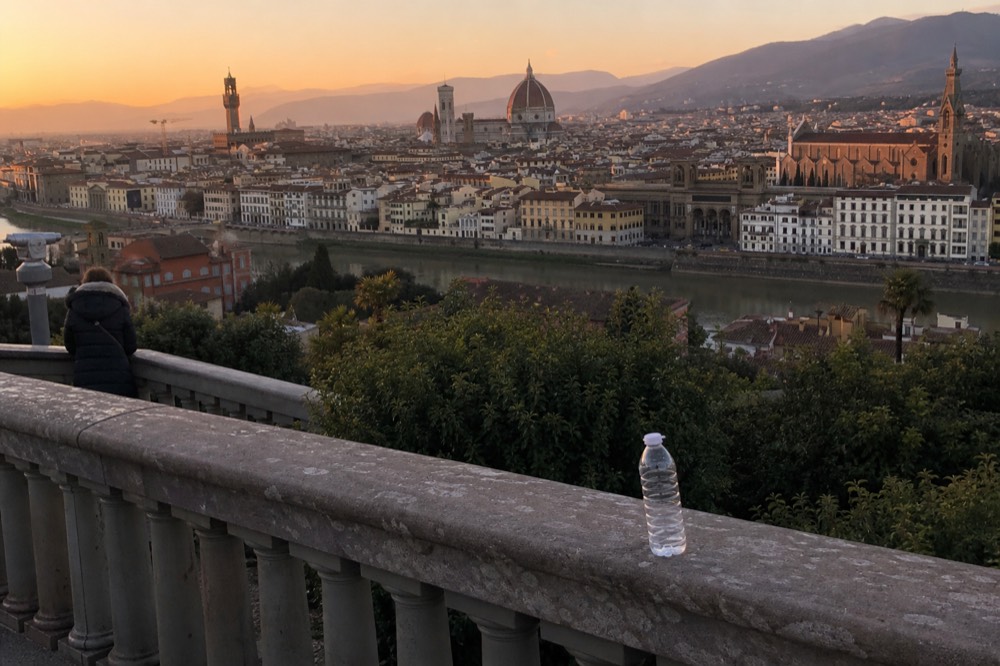 A sunset view over Florence rooftops with the Duomo dome in the distance