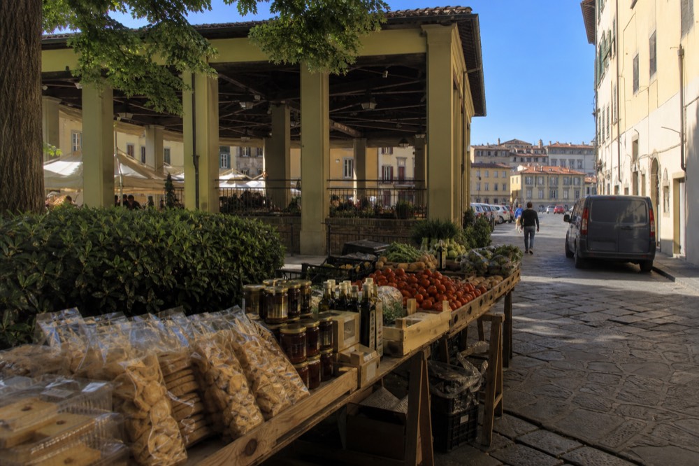 Stall of dry biscuits, jars of preserves and bottles of olive oil at a Florentine market