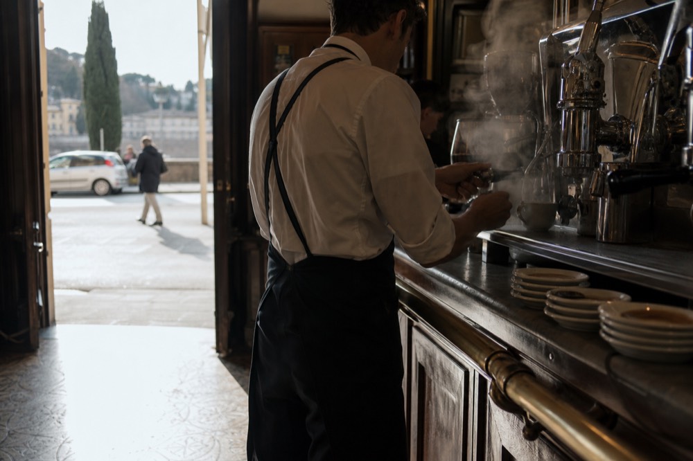 Barista pulling an espresso shot at a Florence coffee bar