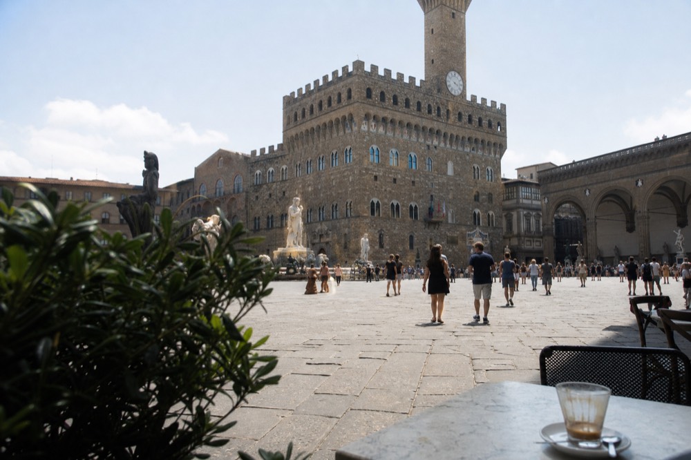 Piazza della Signoria with the Palazzo Vecchio tower and outdoor café tables
