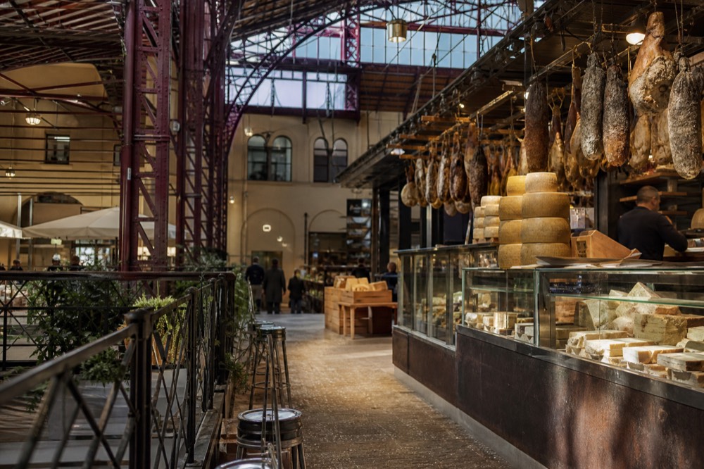 Mercato Centrale food hall stalls with hanging meats and cheese displays