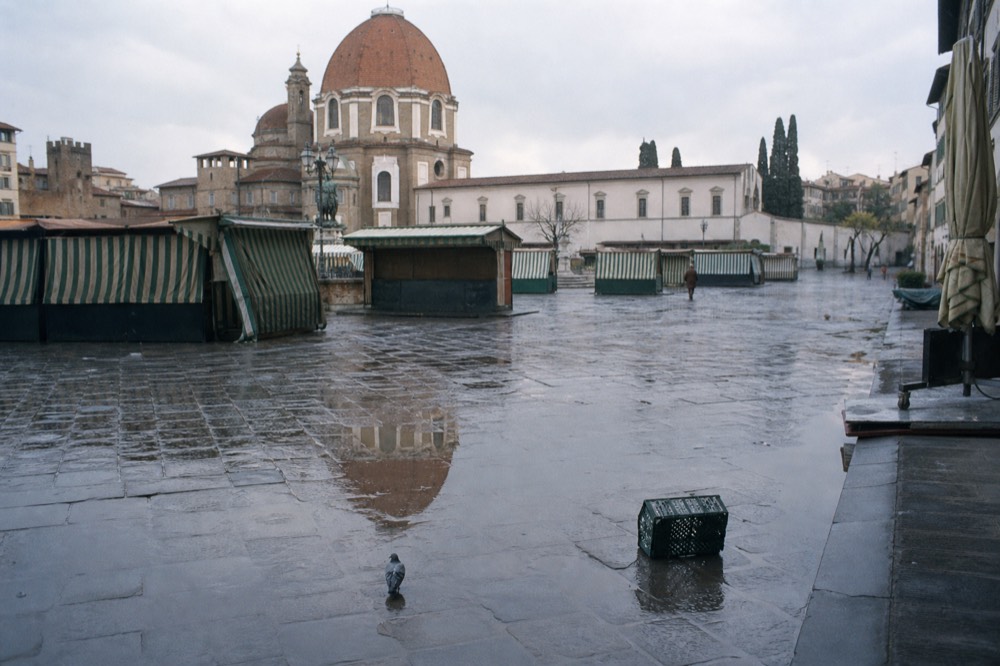 Morning light over empty market stalls before opening in a Florentine square