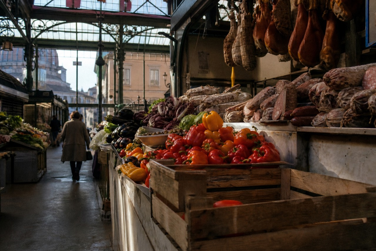 A display of fresh produce and cured meats at a Florence market stall
