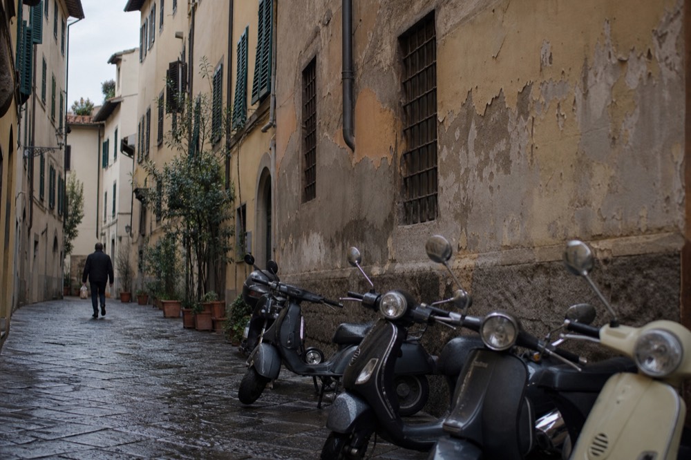 Empty morning street with parked bicycles and old plaster facades